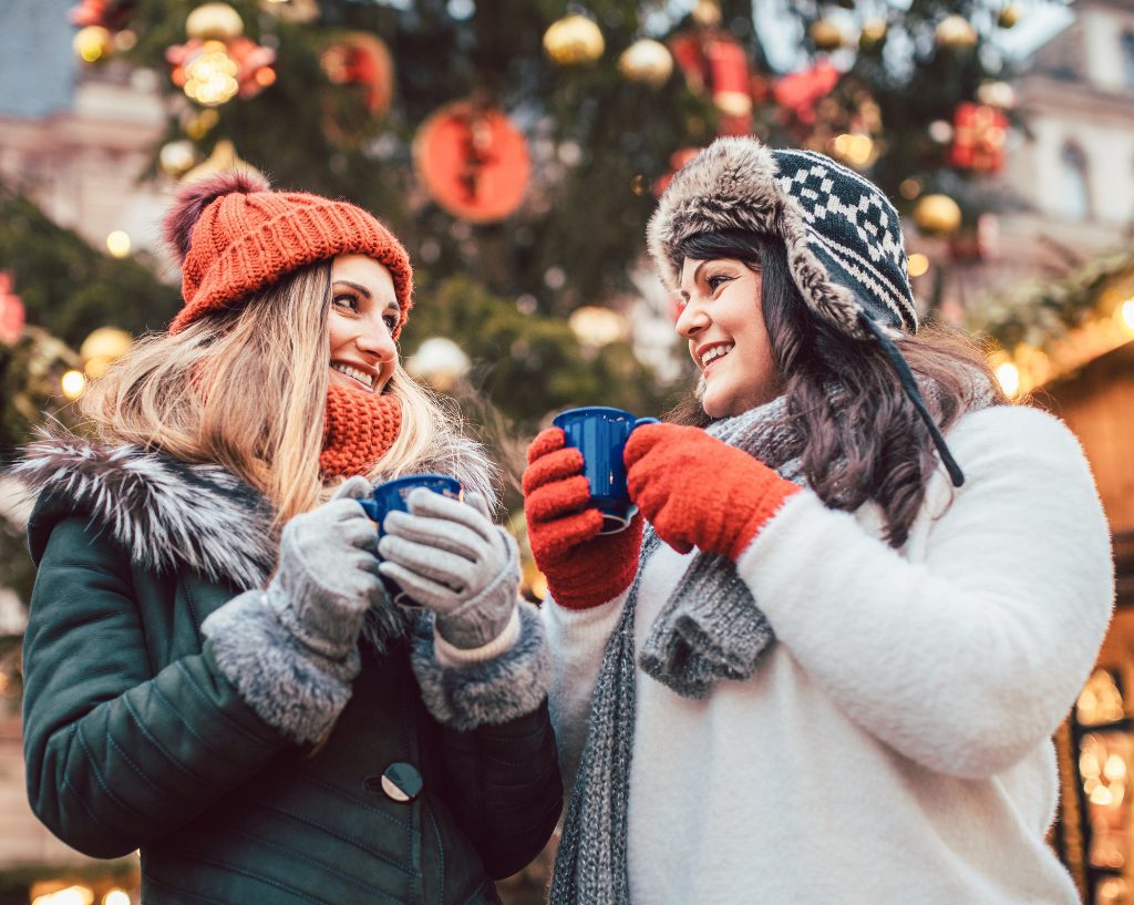 Two women drinking warm wine